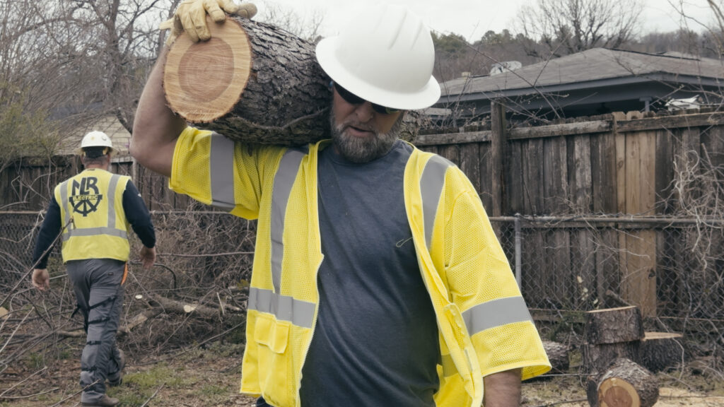 Tree Trimming Crew removing waste from yard.