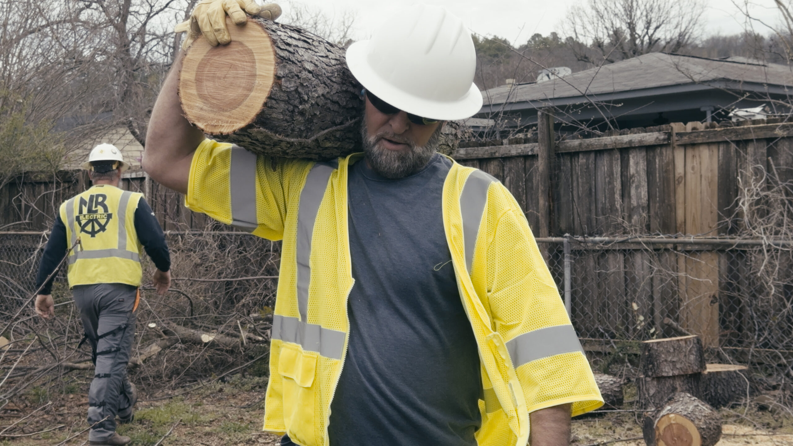 Tree Trimming Crew removing waste from yard.